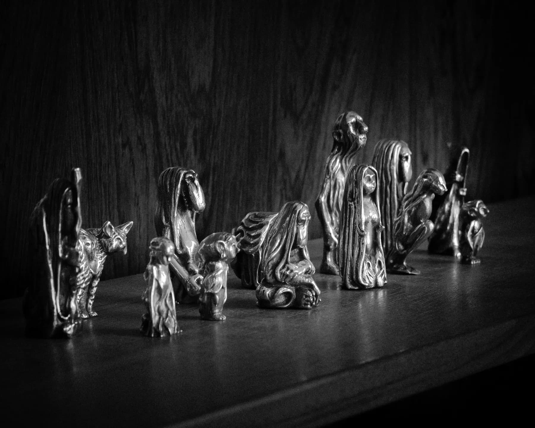 A row of Trollheim charms on a wooden shelf